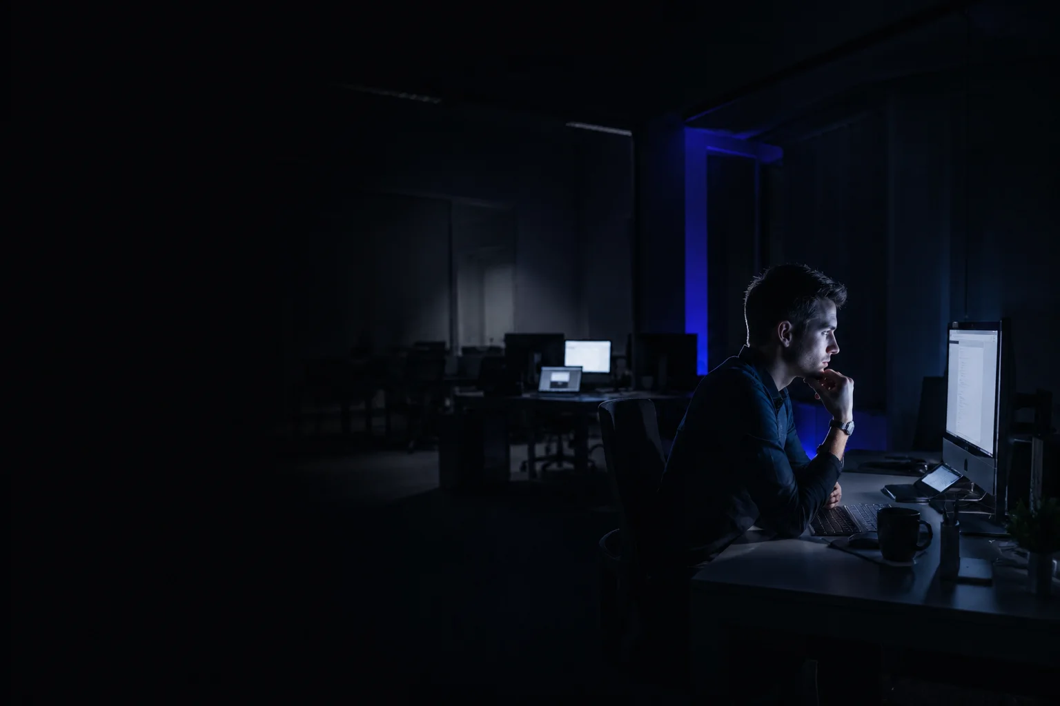 Arbeit im NAMMERT-Büro am Abend, Bildschirmlicht im dunklen Raum