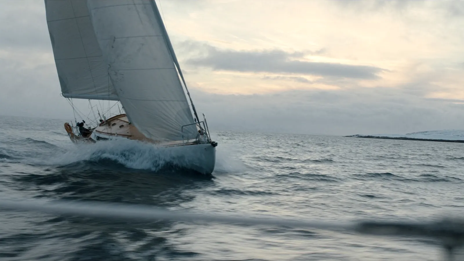 A cruising yacht heeling with spray over the bow in a fresh breeze